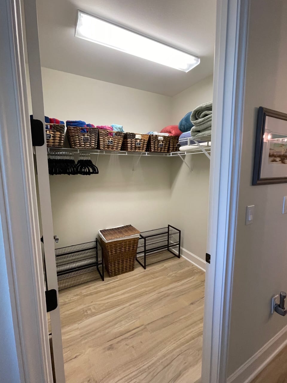 Huge walk-in closet in the Primary Suite with pool & beach towels, & extra linen