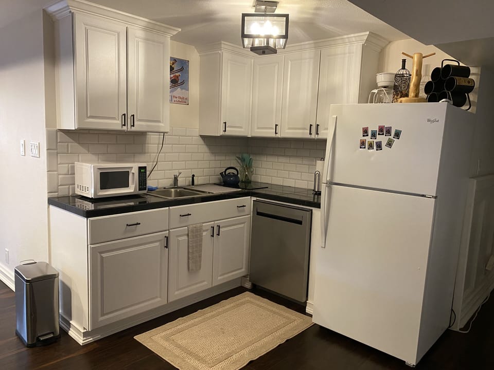 Kitchen with dishwasher, full fridge, 2 burner stove top,  coffee maker, etc. 