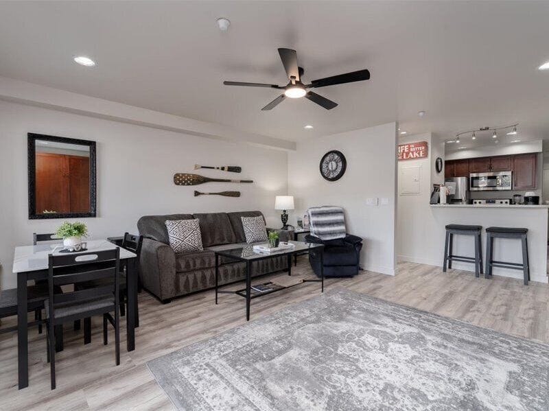 Unwind in your open-concept space with stylish furnishings, modern ceiling fan, and seamless flow between living and dining areas.