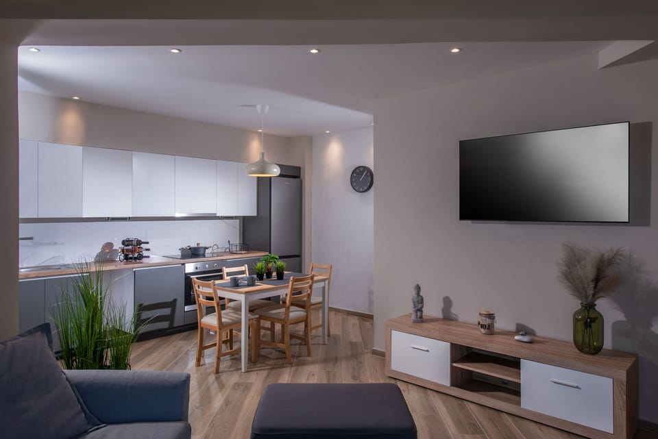 View of kitchen and TV in living room