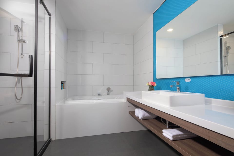 Suite, 1 King Bed | Bathroom | Shower, rainfall showerhead, designer toiletries, hair dryer