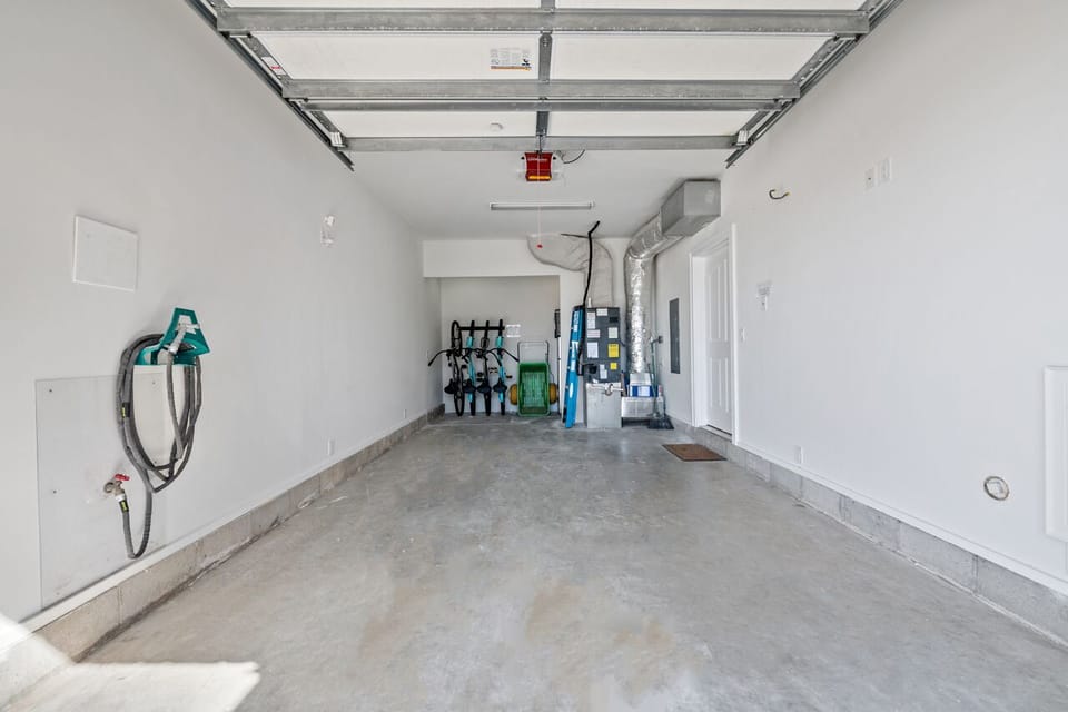 Garage parking with Bikes, fridge and beach toys, cart and rolling cooler.