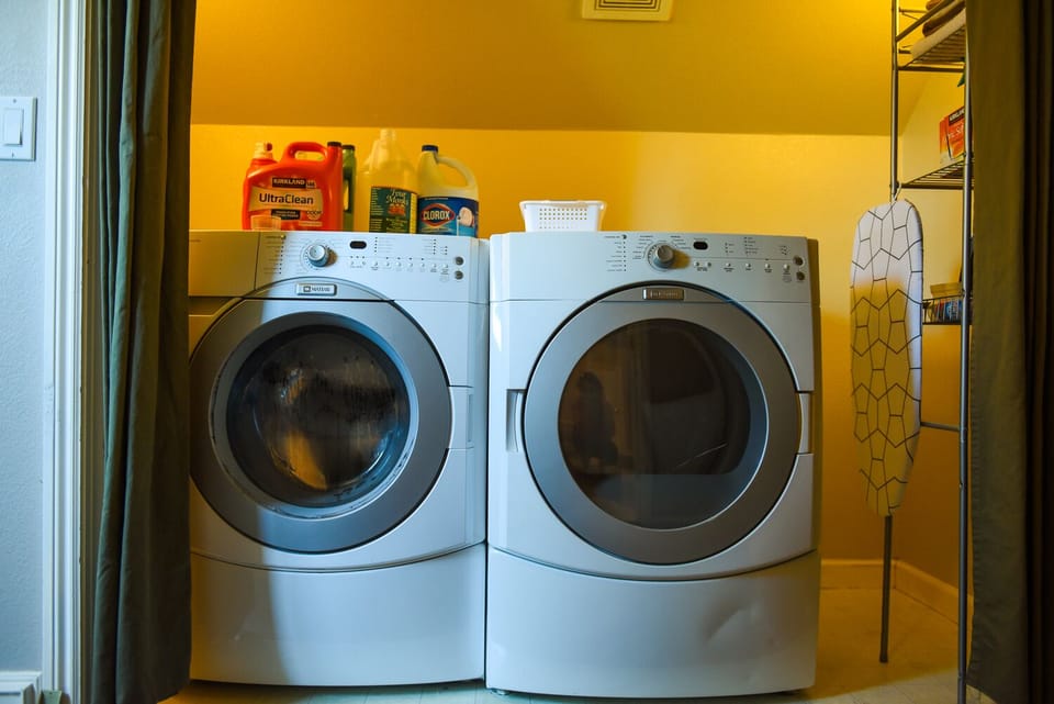 Washer and dryer upstairs, iron and ironing board