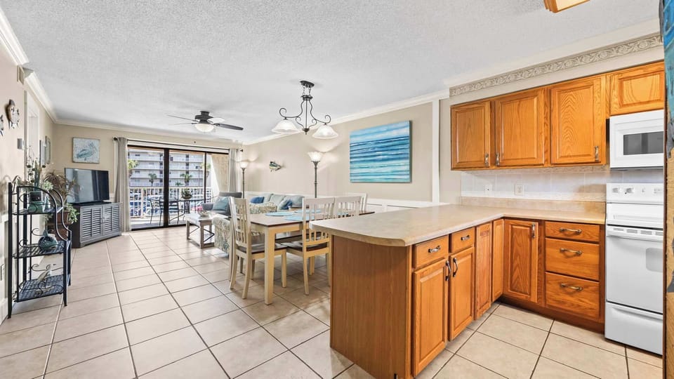 Kitchen overlooks dining and living room areas