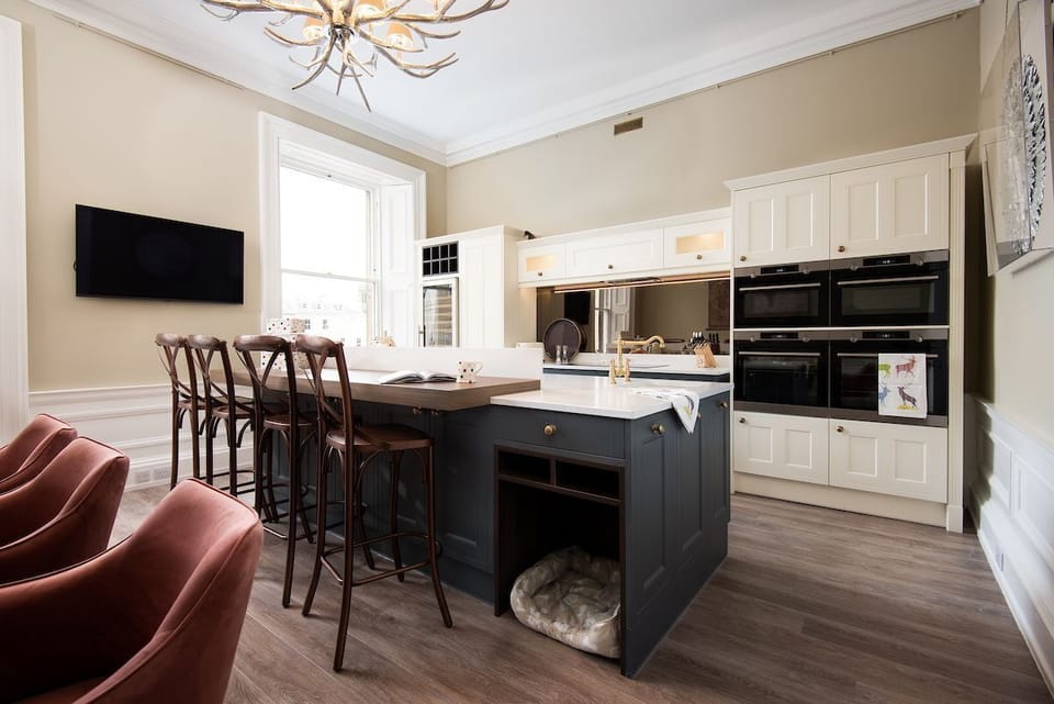 The Linen House - the sleek designer kitchen with double aspect windows offers a perfect spot for watching the comings and goings of life in the town square below