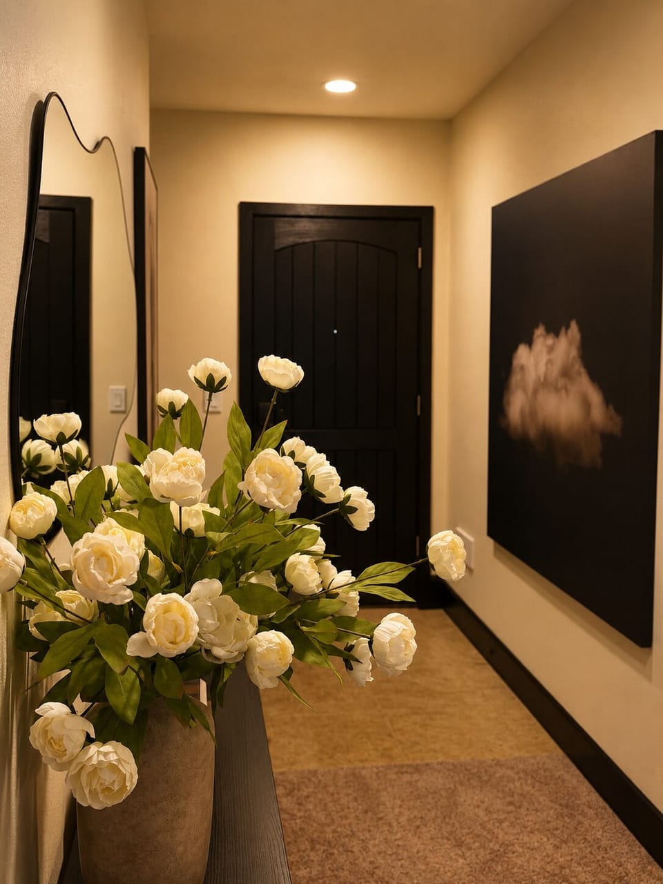 A welcoming entryway greets you with fresh white blooms and warm lighting, setting a peaceful tone the moment you arrive.