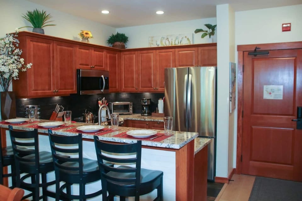Raised countertop with solid wood barstools allows you to comfortably seat 4