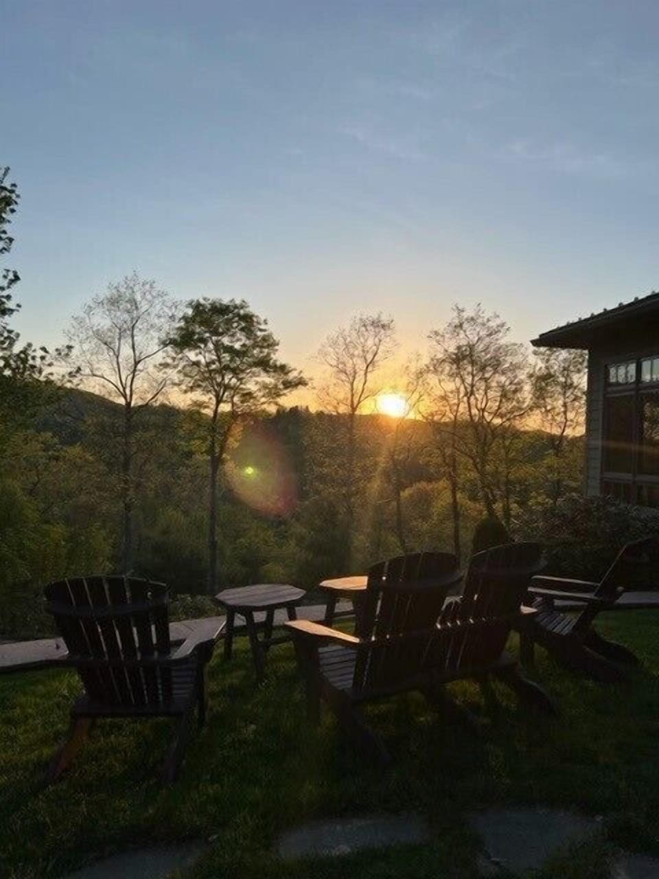 Golden hour from the backyard at Misty Mountain Hop. Pull up a chair and watch the sun dip behind the Blue Ridge hills.