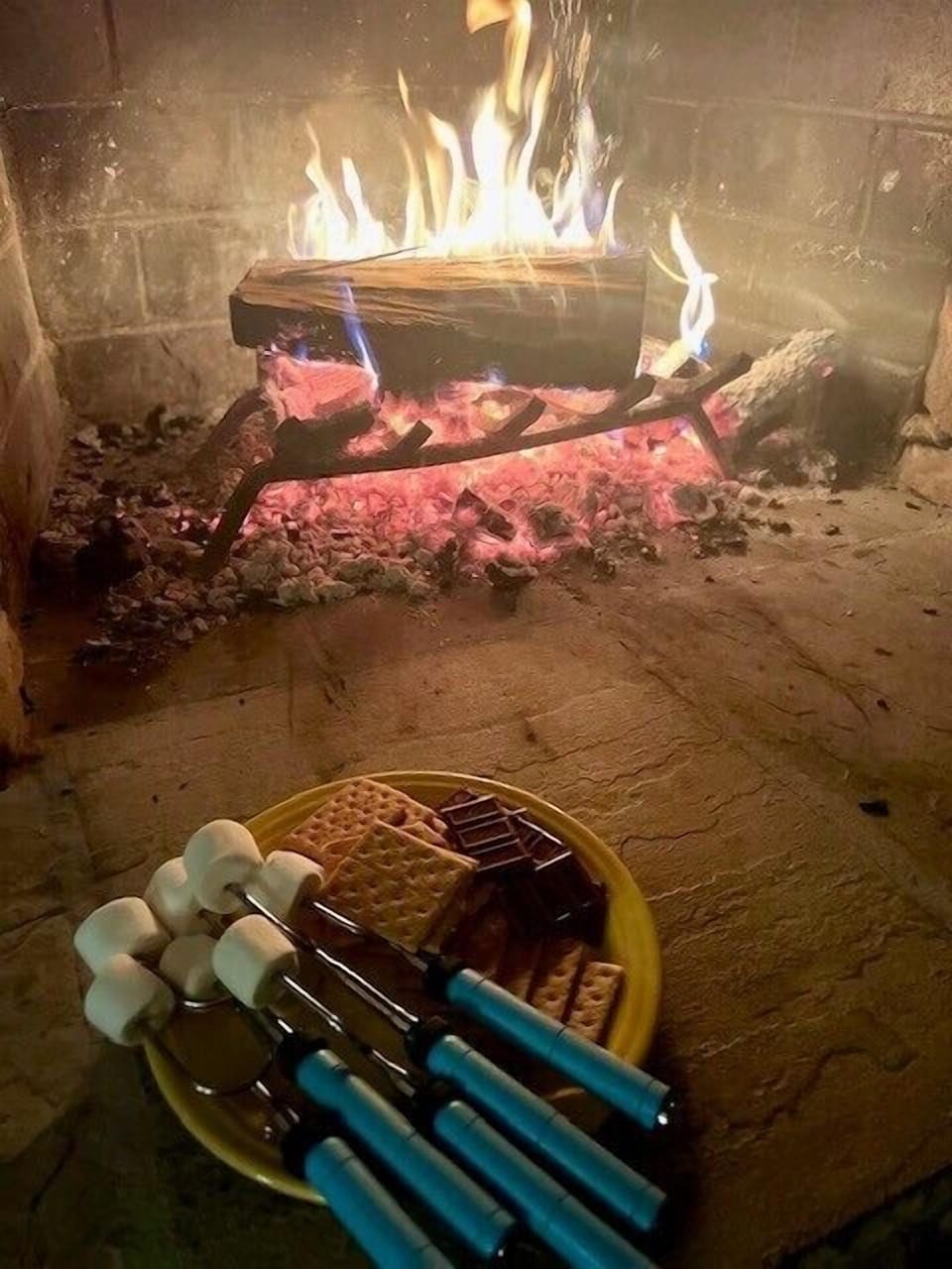 S'mores by the fire at Misty Mountain Hop. Gather the whole crew around the hearth for a sweet Blue Ridge night in.