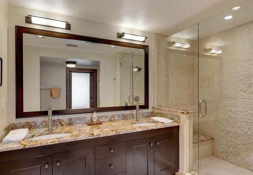 Primary suite double vanity and shower.