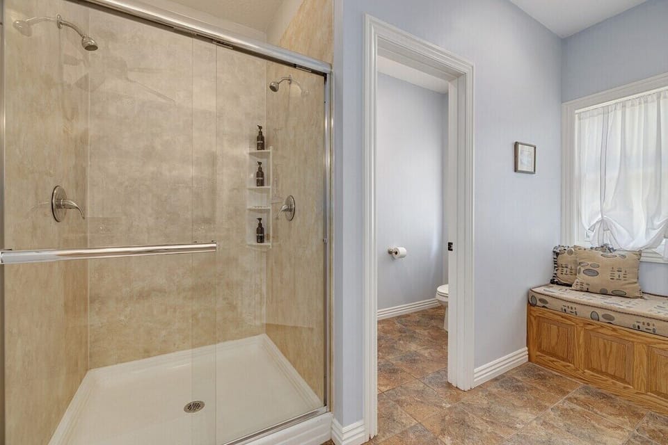 Pictured is the master bathroom's walk-in shower and seating nook.