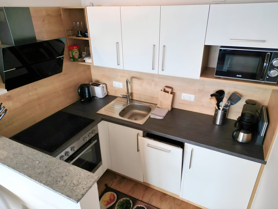 Ferienwohnung design | Private kitchen | Fridge, microwave, stovetop, coffee/tea maker