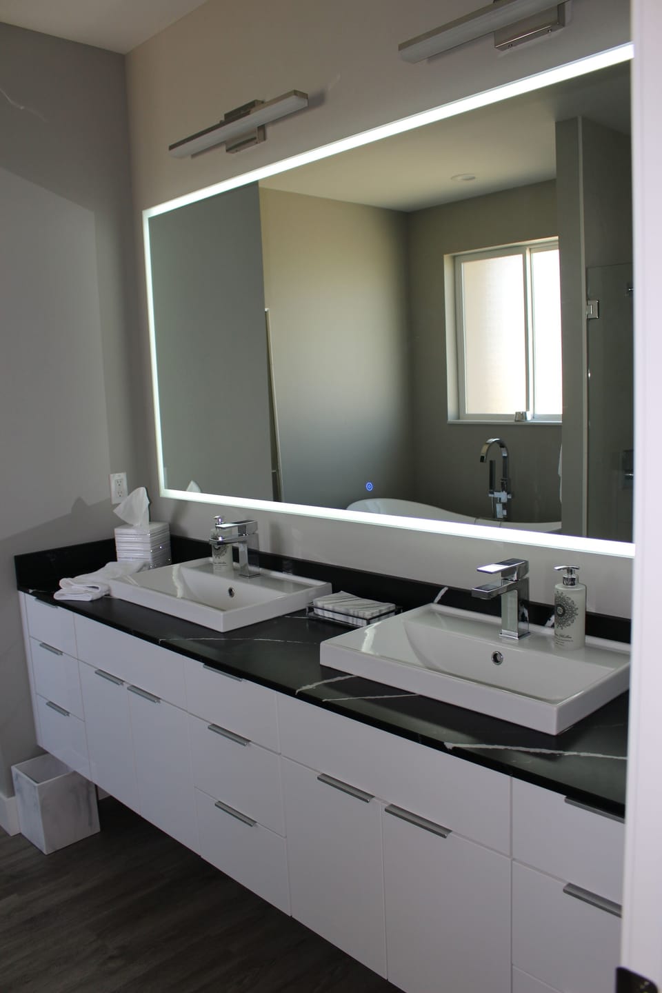 Master bathroom with hotel-style lighted mirrors.