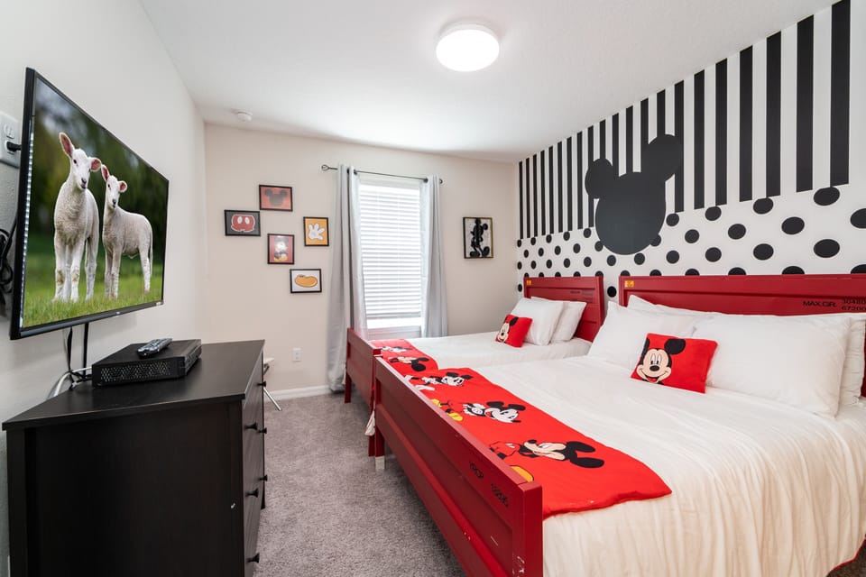 Bedroom 5 has famous mouse themed decor with single and double beds and a flatscreen TV.  Also has en-suite bathroom.