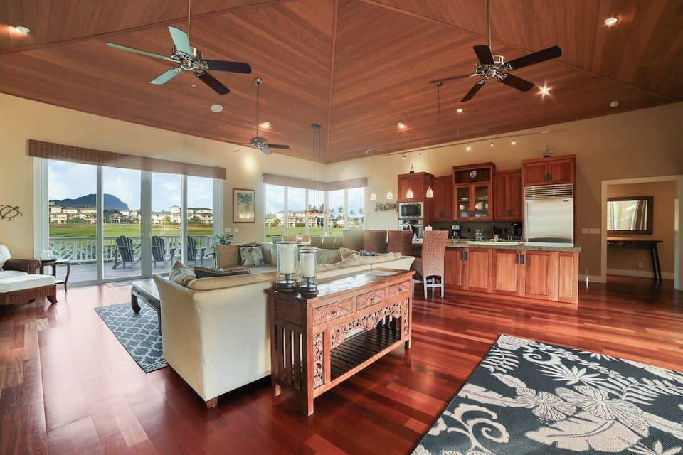 Another view of the living room, kitchen, and dining room
