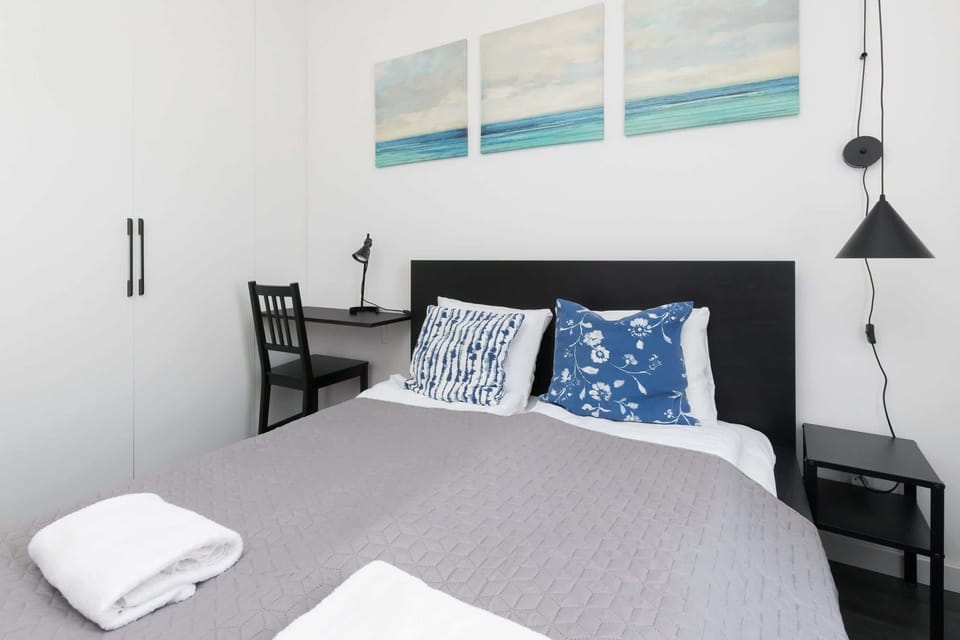 The same bedroom from a different perspective, showing a wardrobe and the full bed setup.