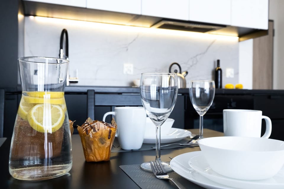 A dining table set for meals, with stylish tableware and glasses adding an elegant touch.