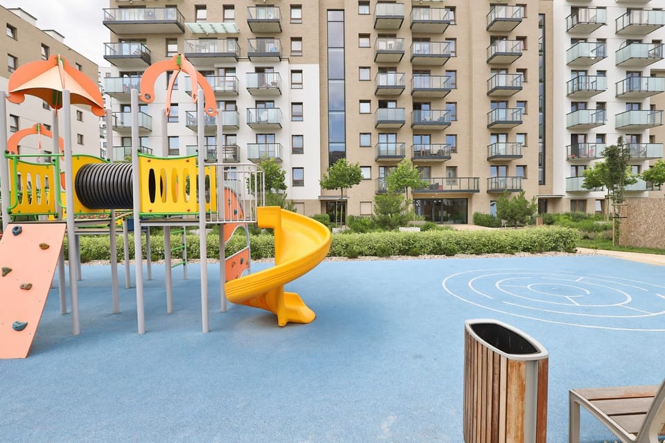 A playground featuring colorful equipment, including a slide and a water play area for children.