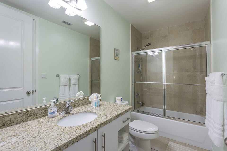 The full guest bathroom includes a convenient tub and shower combination.