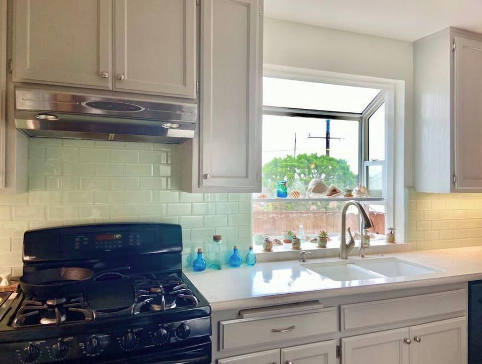 kitchen with greenhouse garden window, double porcelain sink, subway glass tile