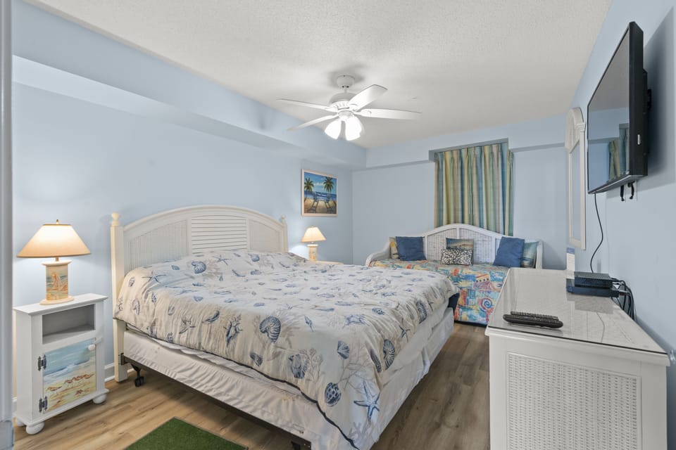 This spacious bedroom provides room for you and the kids.