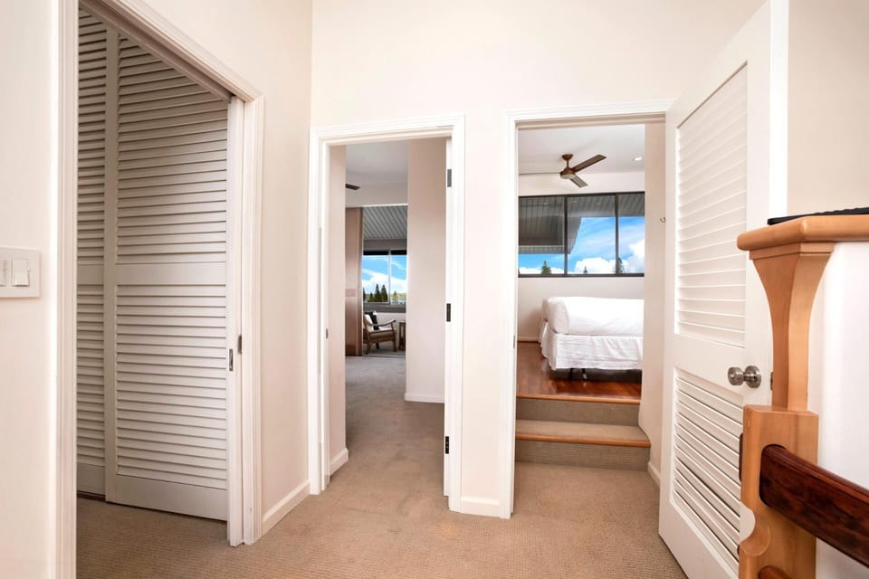 Step into this bright and inviting hallway that seamlessly connects two serene bedrooms, each offering lush views and cozy charm    