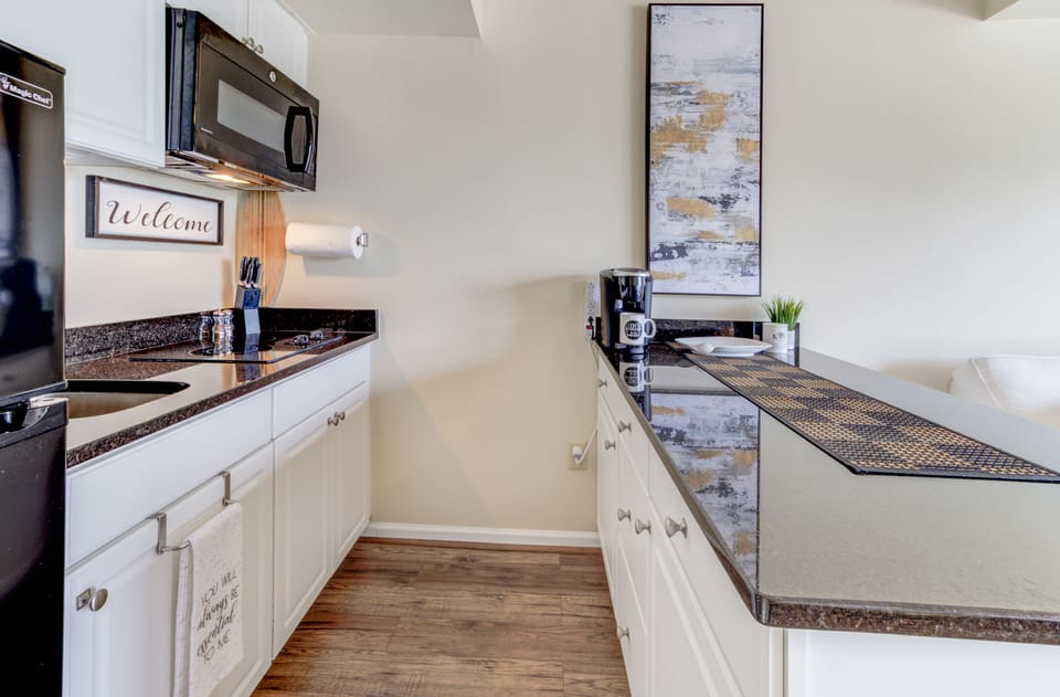 Kitchen area wih stovetop & convection oven.