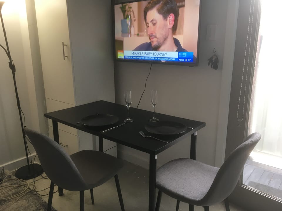 Table set for two , extra chairs provided if required .