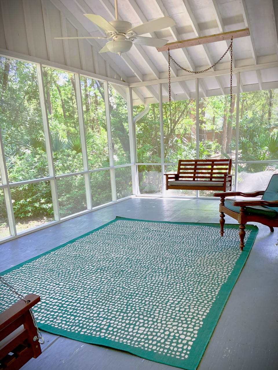 Screened in porch. Side yard has privacy fence, firepit, deck, outdoor shower.