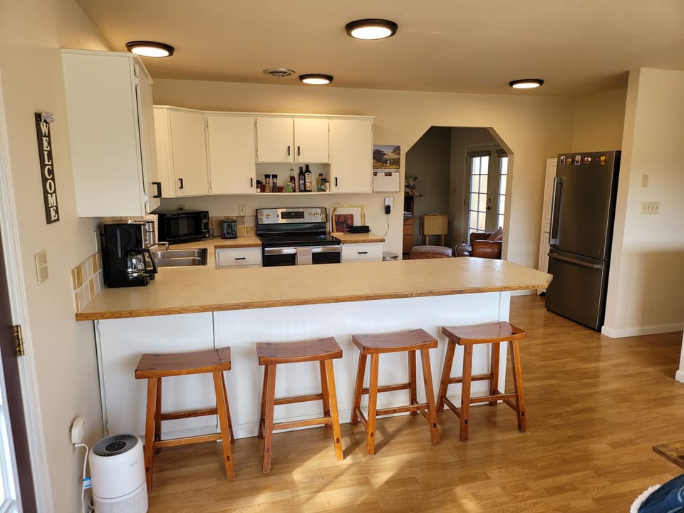 Front entry view into kitchen, main living, and hallway to bedrooms & bathroom.
