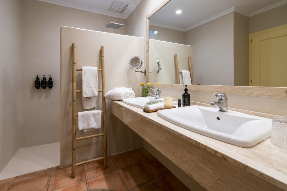 La Terraza Room | Bathroom | Rainfall showerhead, hair dryer, bidet, towels