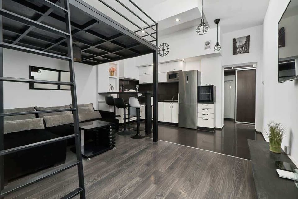 A perspective highlighting the open-plan layout with the living room leading into a compact kitchen.