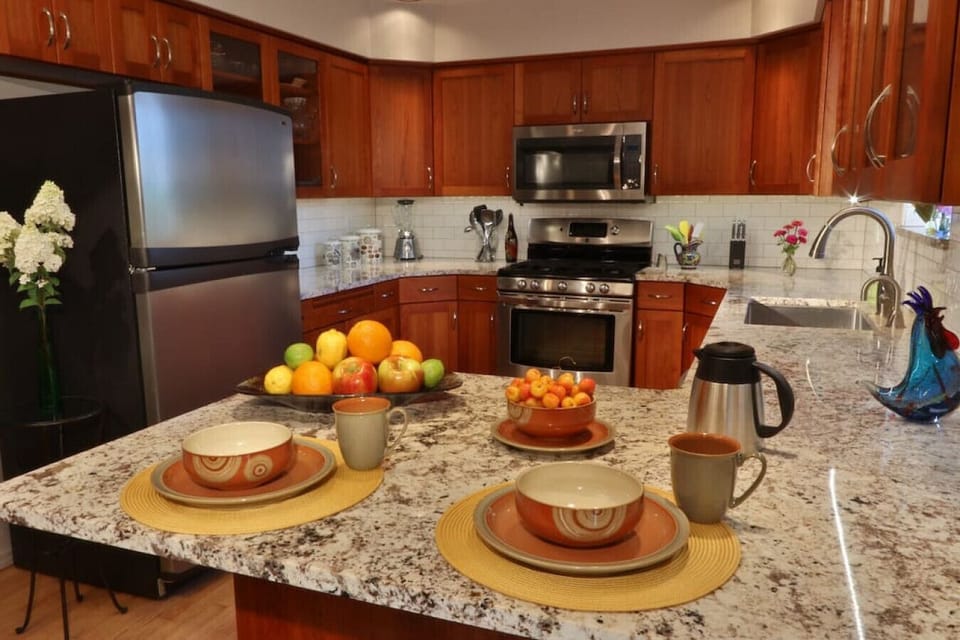Kitchen with stainless steel oven, microwave, and refrigerator