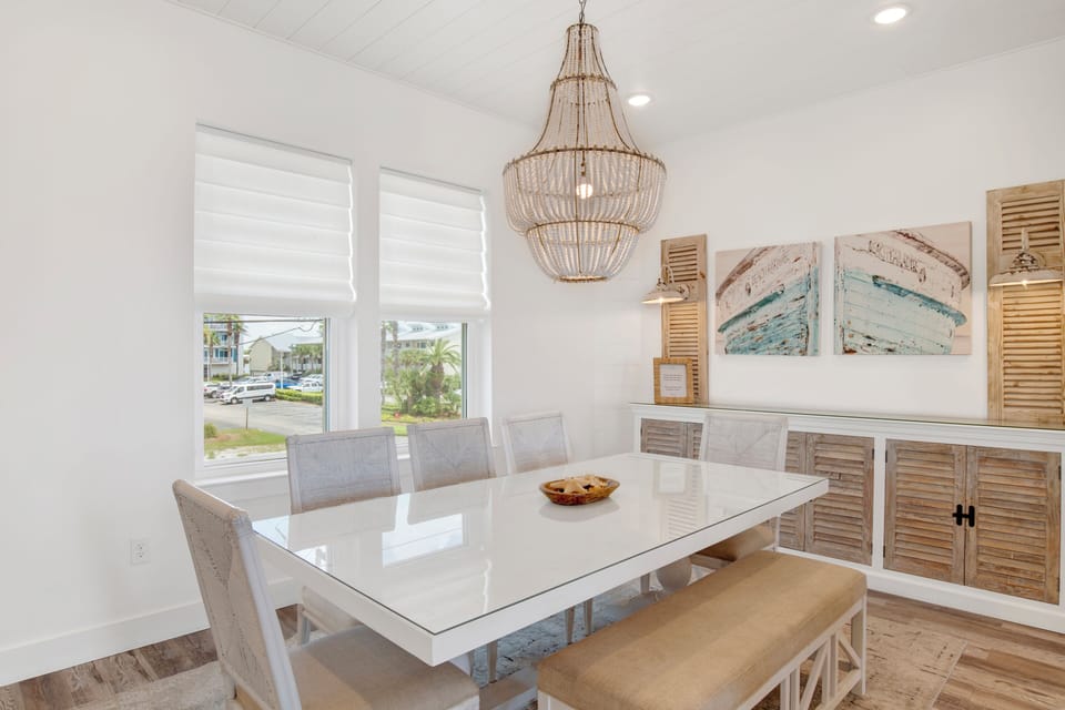 The dining table seats 8 with additional seating at the kitchen island