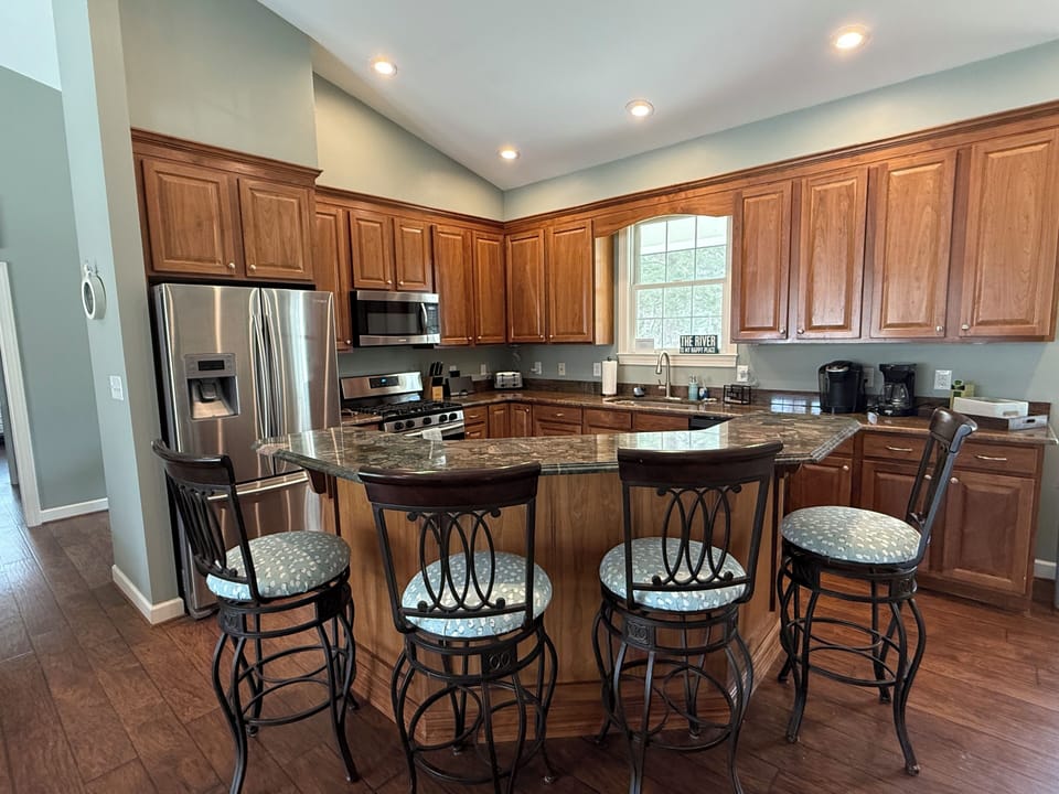 Chef’s kitchen with bar seating for four 