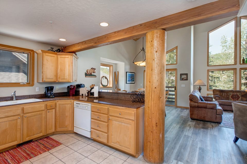 Fully Equipped Kitchen with vast counter-space, stone countertops, Whirlpool appliances, and bar seating for three