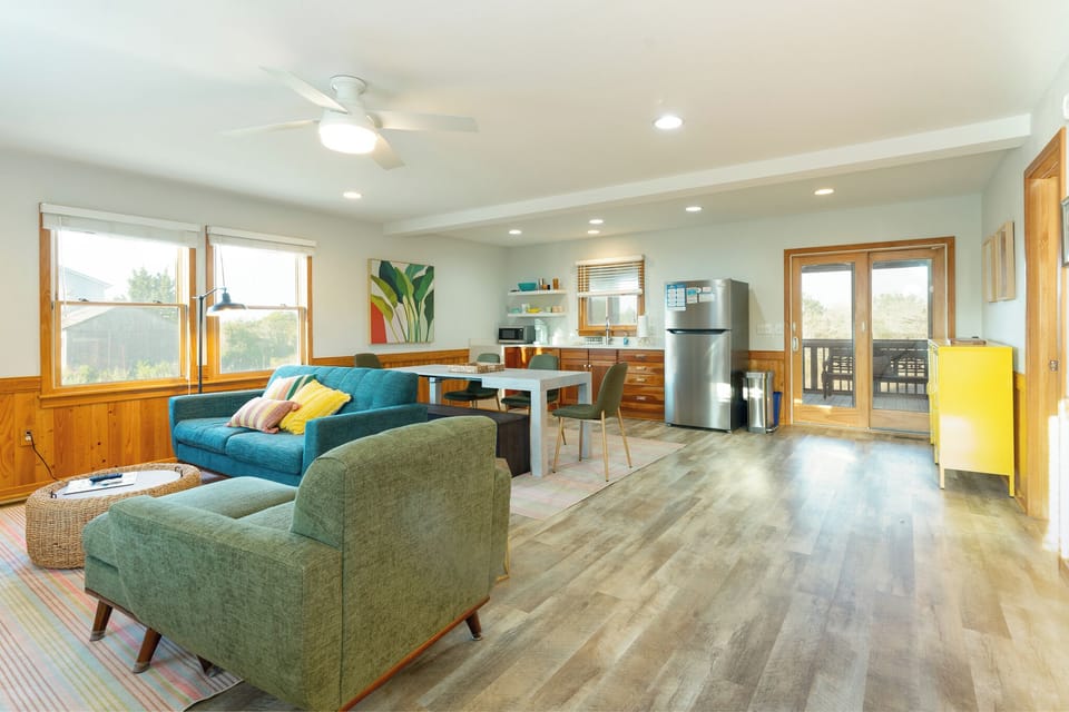 Relax in your bright open-plan space with colorful furnishings, full kitchen, and cozy seating perfect for unwinding after exploring.