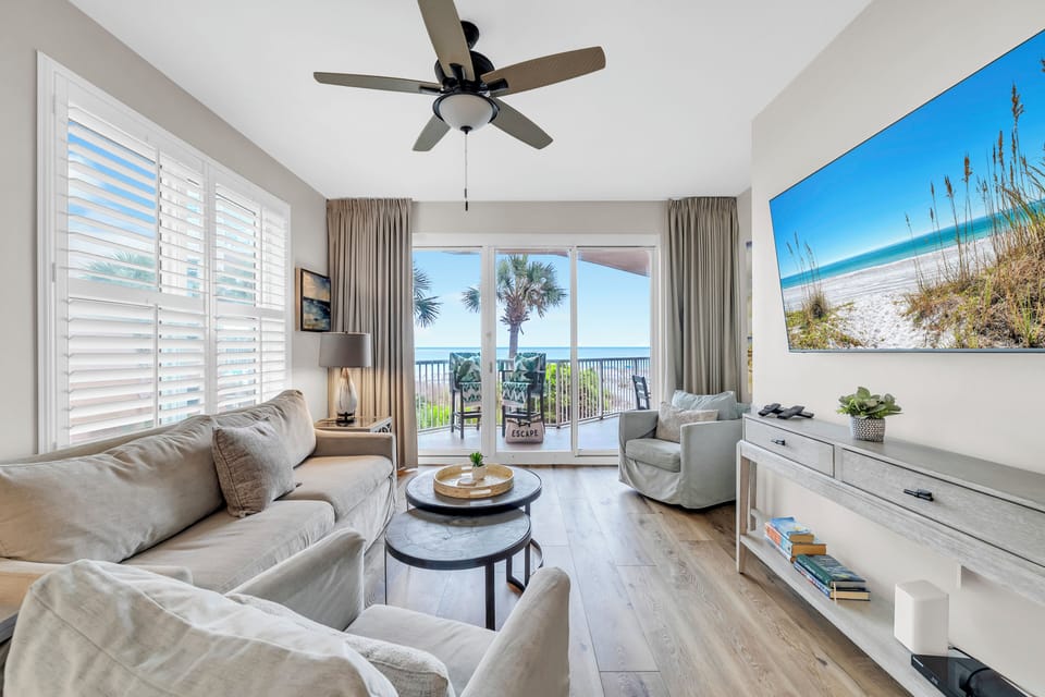 Sink into plush coastal comfort while ocean breezes flow through your bright living space, complete with calming beach artwork and balcony access.