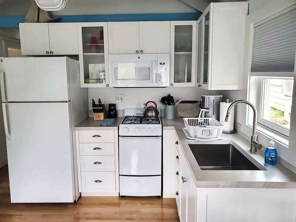 Kitchen: new cabinets, wood countertops, stocked fridge, stove, microwave, etc.