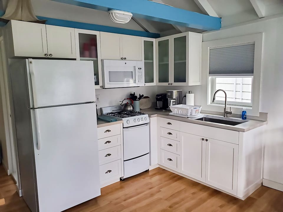 New Kitchen Cabinets and wood countertops stocked with all cooking Utensils.