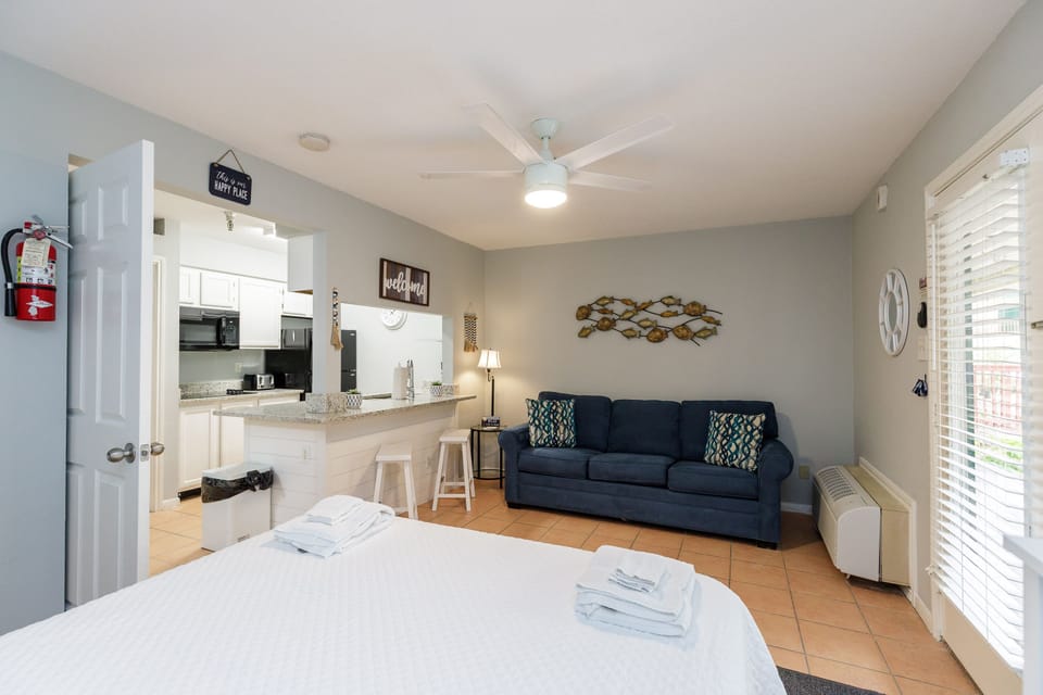 Unwind in your spacious studio featuring a plush bed, cozy living area, and fully-equipped kitchen—perfect for relaxing after exploring nearby attractions.