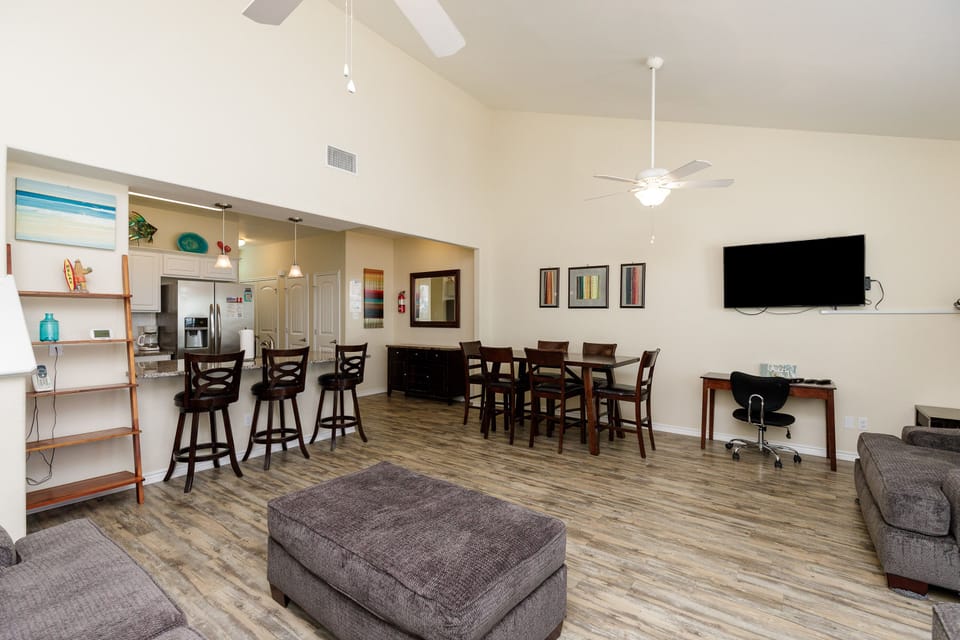 Relax in your spacious open-plan living area with modern kitchen, comfortable seating, and entertainment—perfect for gathering with loved ones.