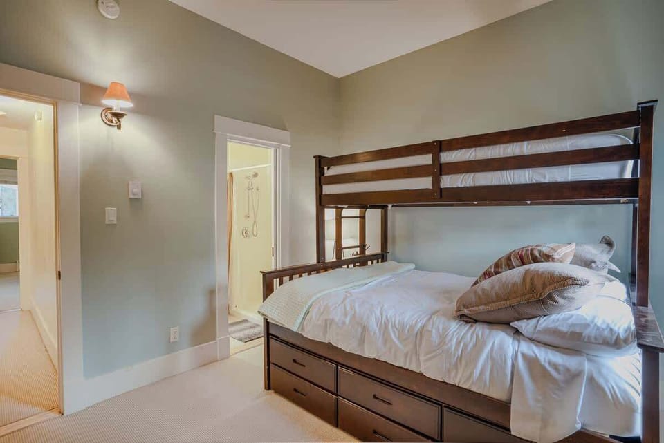New Trundle bed with a Full-sized bed in the middle, a Twin on top and another Twin bed that pulls out on the bottom level - all with new plush bedding. Bedroom to the right on the second level. 