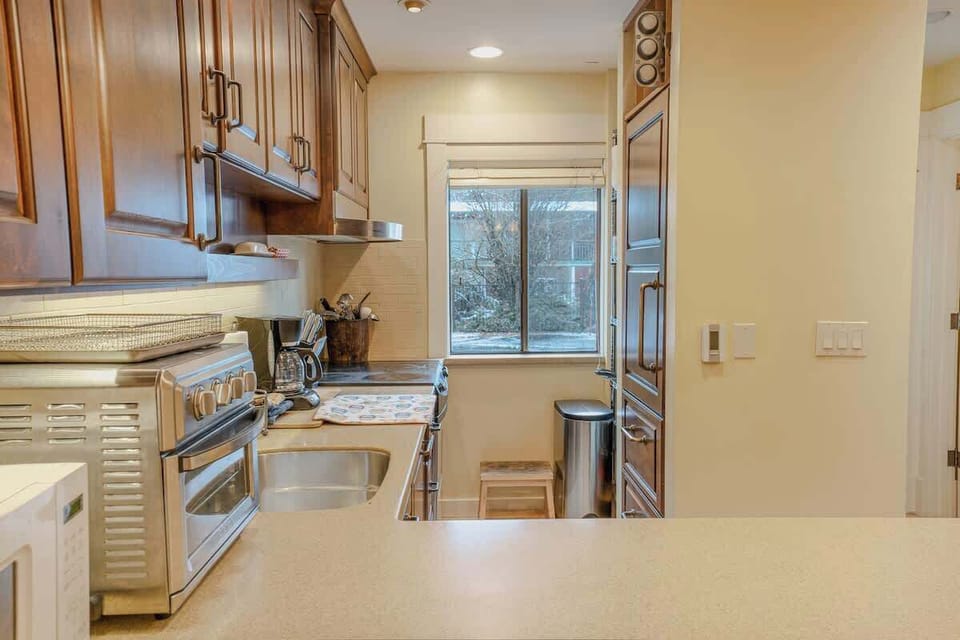 Fully Stocked Kitchen with Custom Fridge Shown on the Right