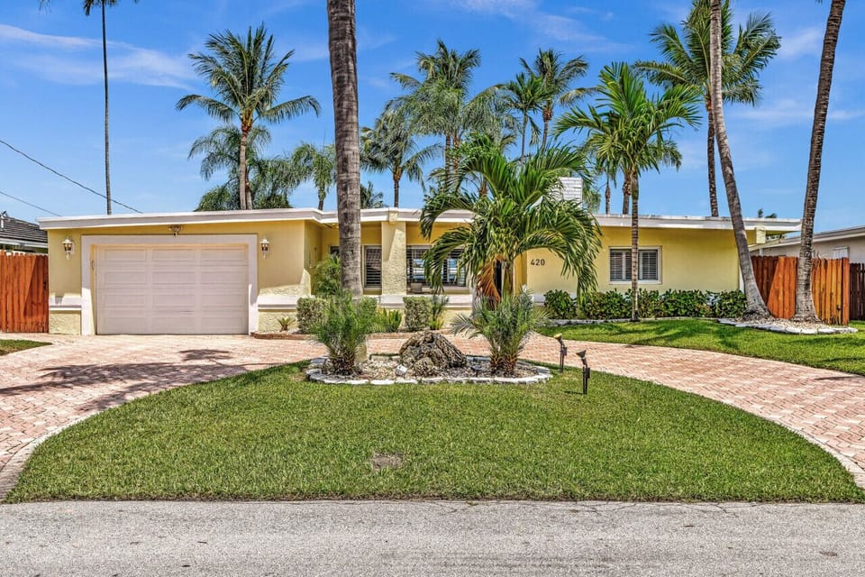 Beautifully landscaped front yard with wrap around driveway that fits 4-5 cars