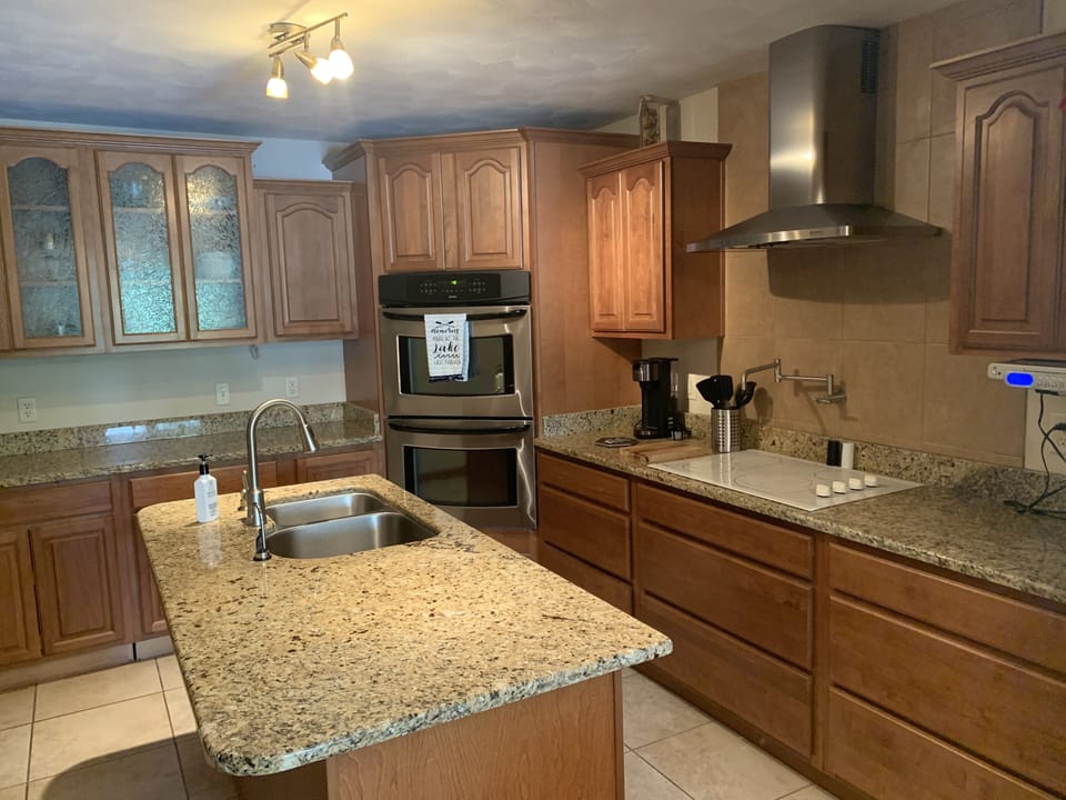 Extra cooking amenities like pot filler, island, double ovens, and hood. 