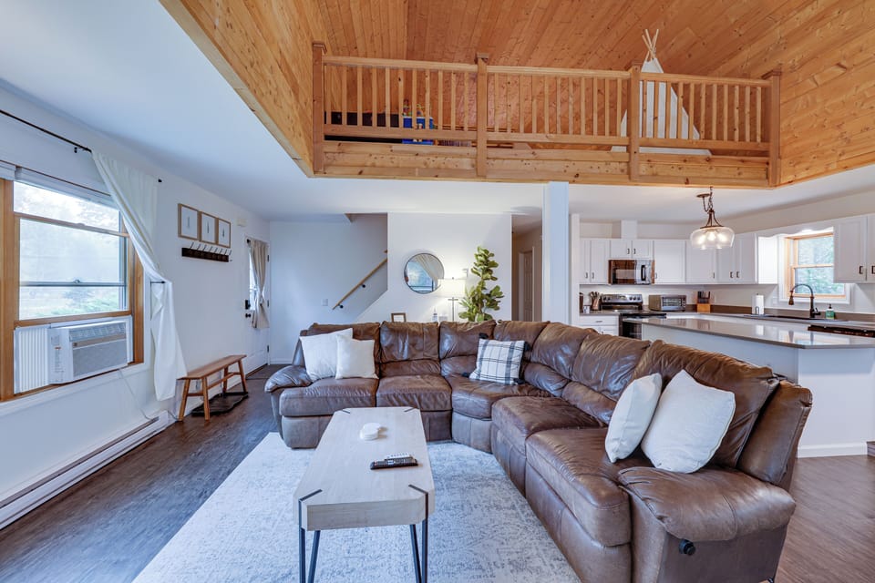 The downstairs opens up to the loft + beautiful pine ceilings.  Bright and open!