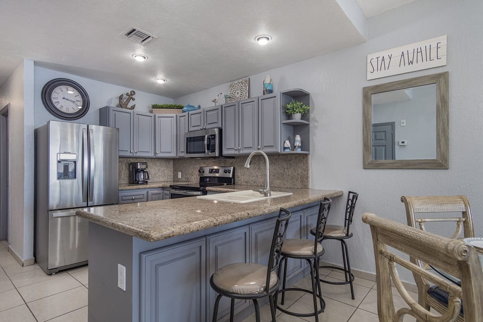 Kitchen has bar stools for extra seating