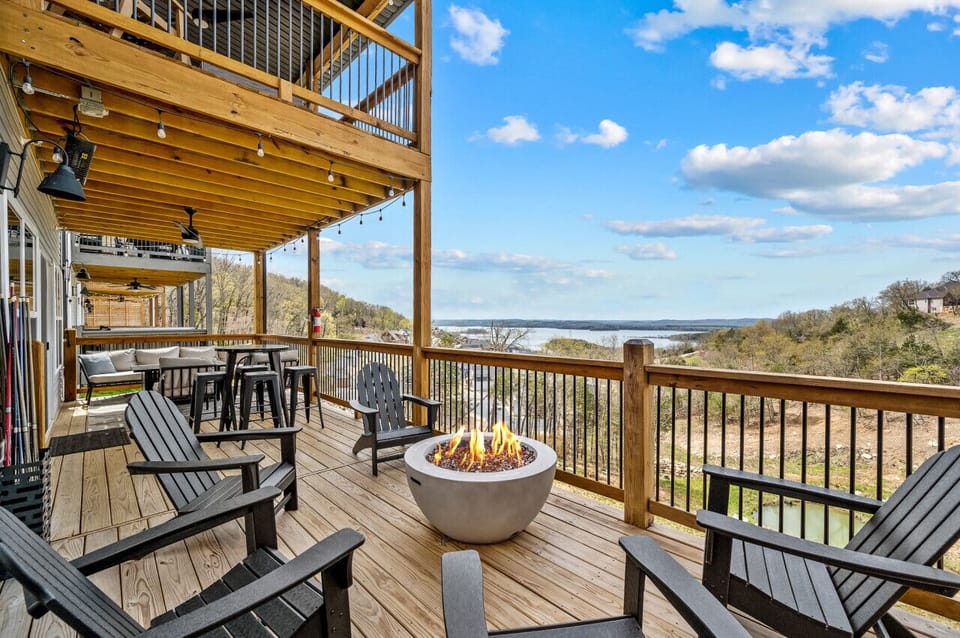 Lower level deck with fire pit, Adirondack chairs, large Weber grill, and a great lake view!