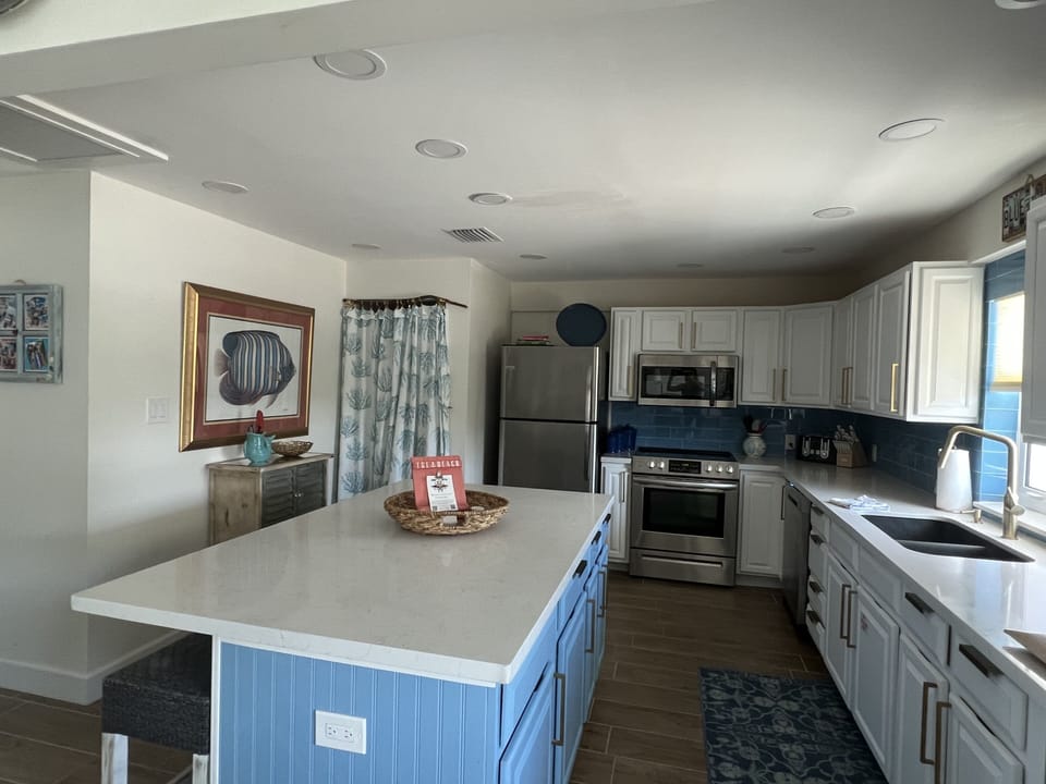 Upstairs kitchen w/ washer/dryer.